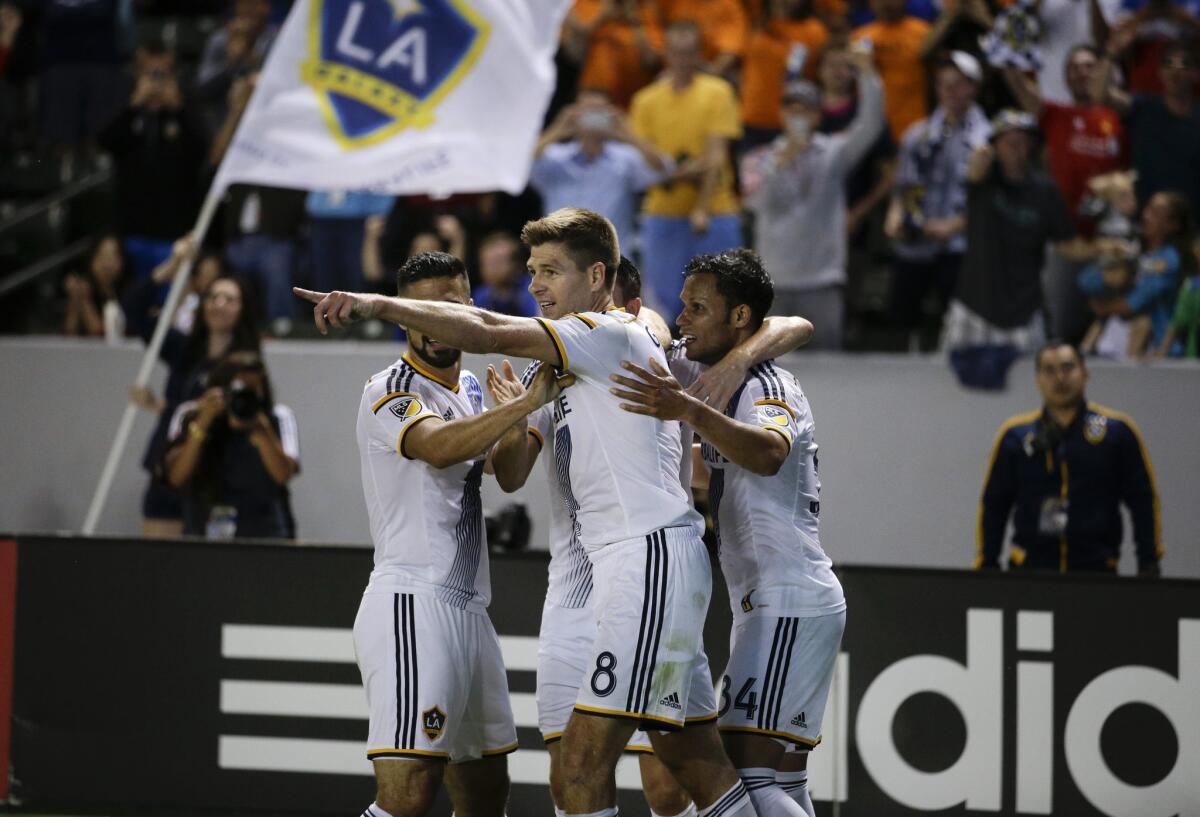 Los Angeles Galaxy's Steven Gerrard, center, of England, celebrates his debut goal for the team during the first half of an MLS soccer match against the San Jose Earthquakes, Friday, July 17, 2015, in Carson, Calif. (AP Photo/Jae C. Hong)