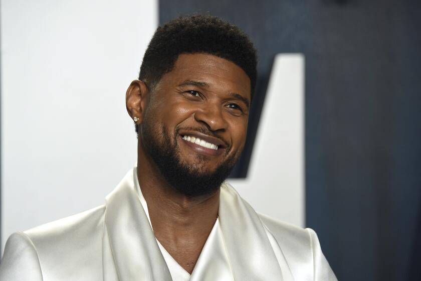 FILE - Usher arrives at the Vanity Fair Oscar Party on Sunday, Feb. 9, 2020, in Beverly Hills, Calif. The NFL, Apple Music and Roc Nation announced Sunday that Usher will headline the 2024 Super Bowl on Feb. 11 at Allegiant Stadium. The music megastar, who has won eight Grammys, said he's looking forward to performing on the NFL's biggest stage. (Photo by Evan Agostini/Invision/AP, File)