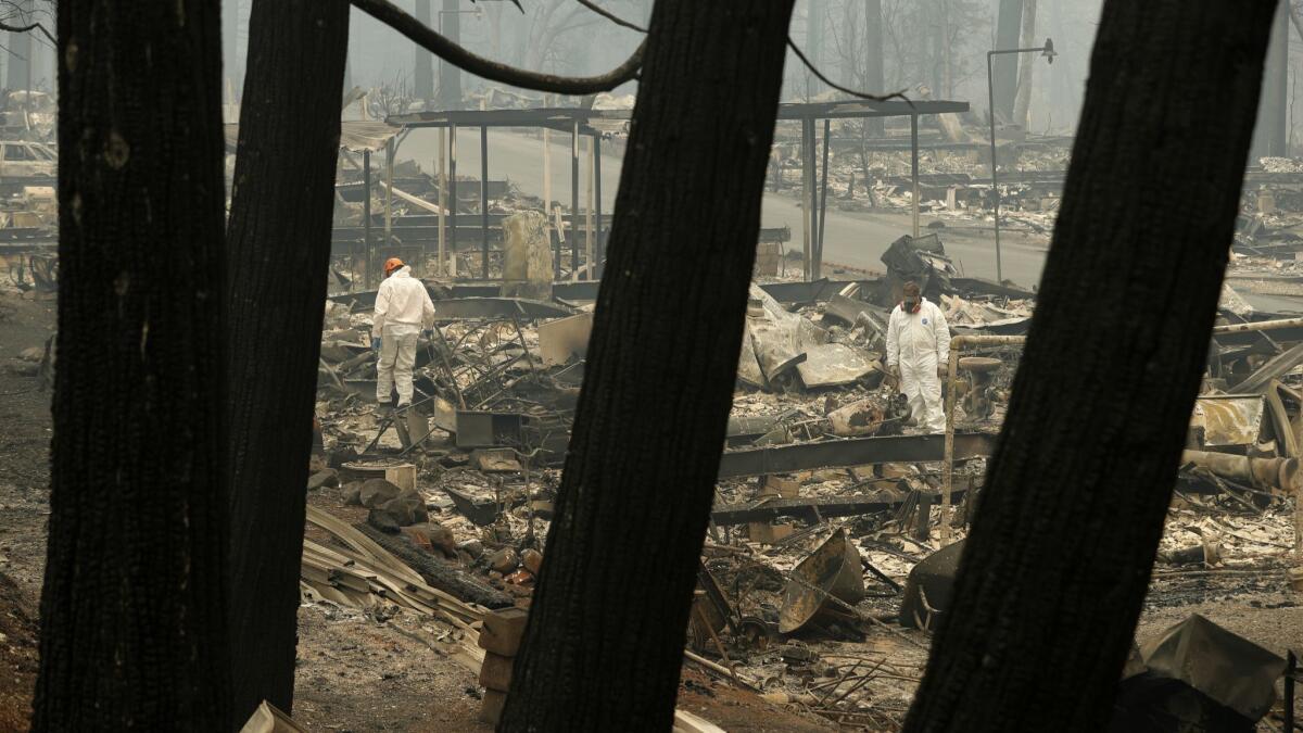 Search and rescue workers look for human remains at a burned-out trailer park in Paradise, Calif.