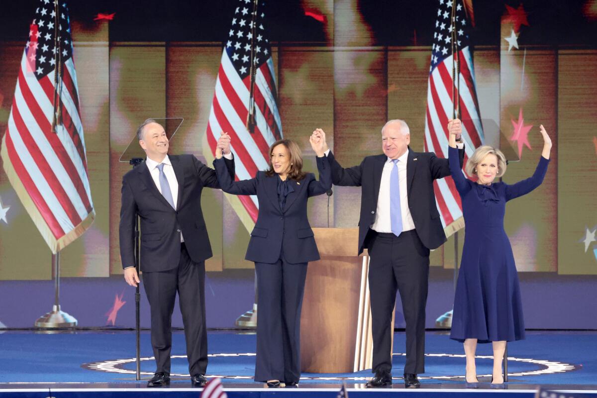 Doug Emhoff, Kamala Harris, Tim Walz and Gwen Walz receive cheers from the DNC crowd after Harris' acceptance speech.