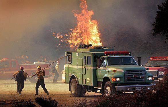 Forest Service firefighters try to contain flames from the Station Fire as it jumps Angeles Crest Highway.