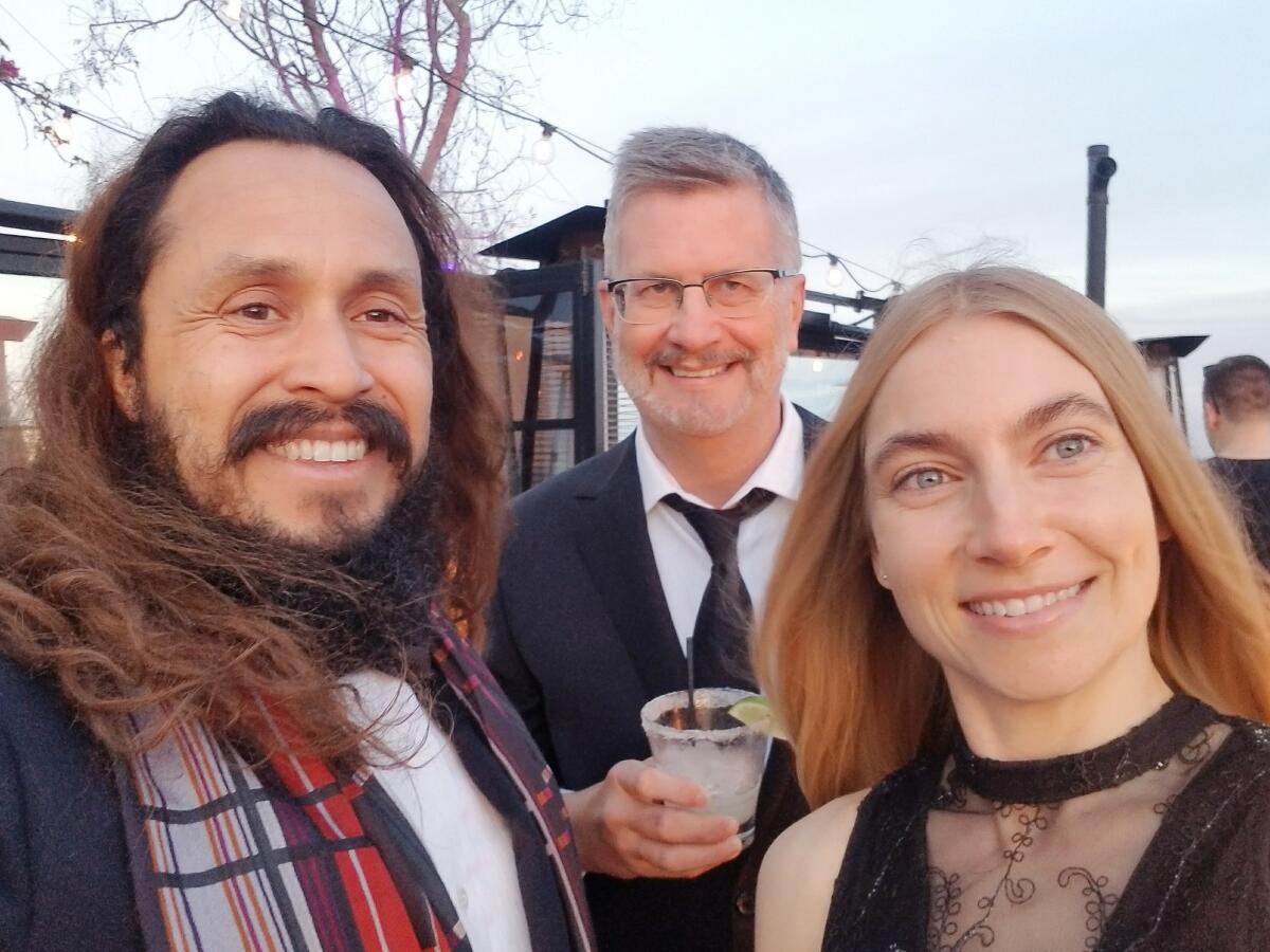 Mark Sawusch, center, with Anthony Flores and Anna Moore in 2017.