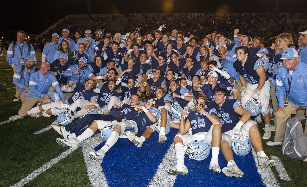 Corona del Mar High School's football team celebrates after defeating Serra 35-27 in the CIF State Division 1-A title game at Cerritos College on Dec. 14.