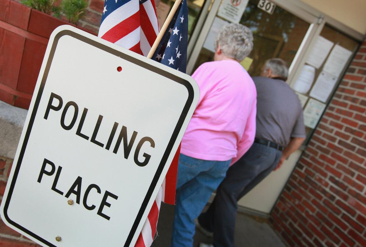 Voters arrive at a polling site in Clinton on Tuesday to cast ballots in Wisconsin's recall election. Milwaukee Mayor Tom Barrett, a Democrat, is trying to unseat Republican Gov. Scott Walker in the recall vote. Opponents of Walker forced a recall election after the governor pushed to change the collective bargaining process for public employees in the state.