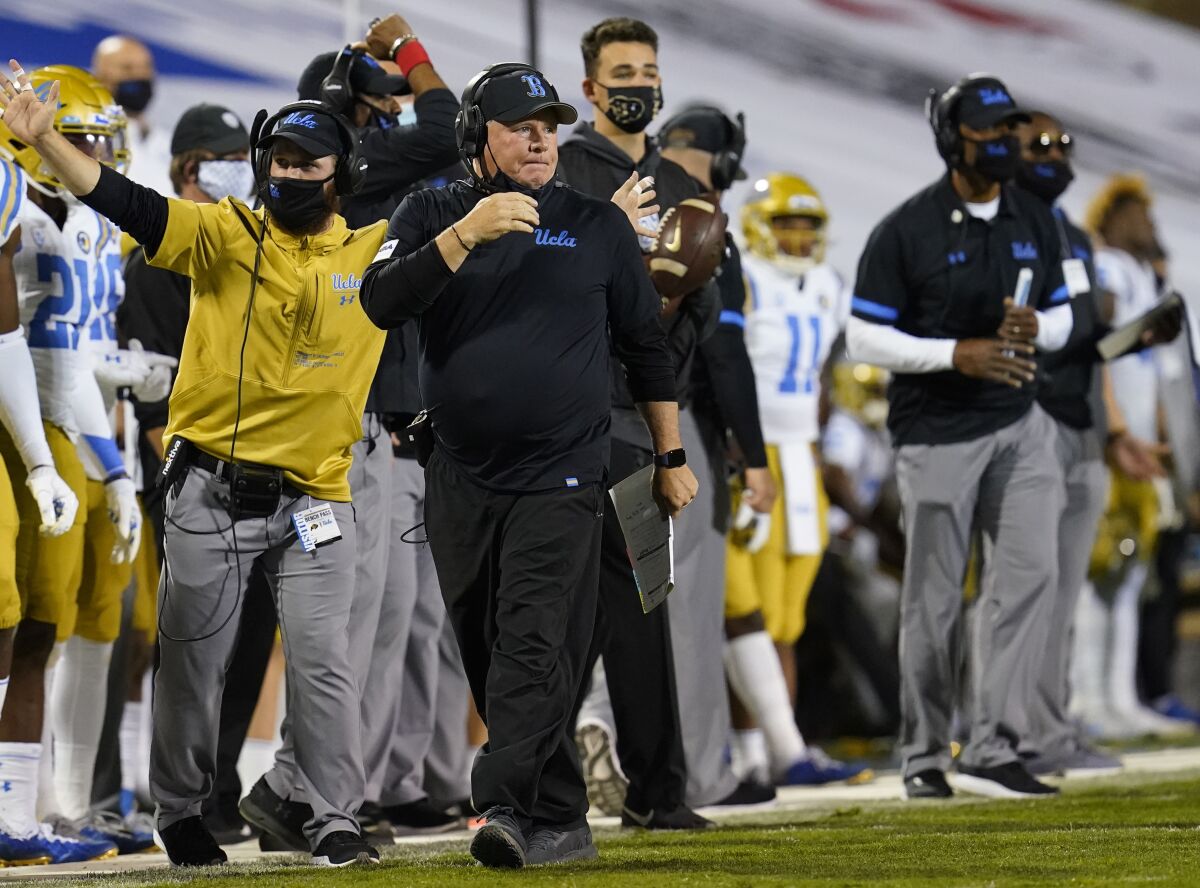 UCLA head football coach Chip Kelly walks along the sideline during a game. 