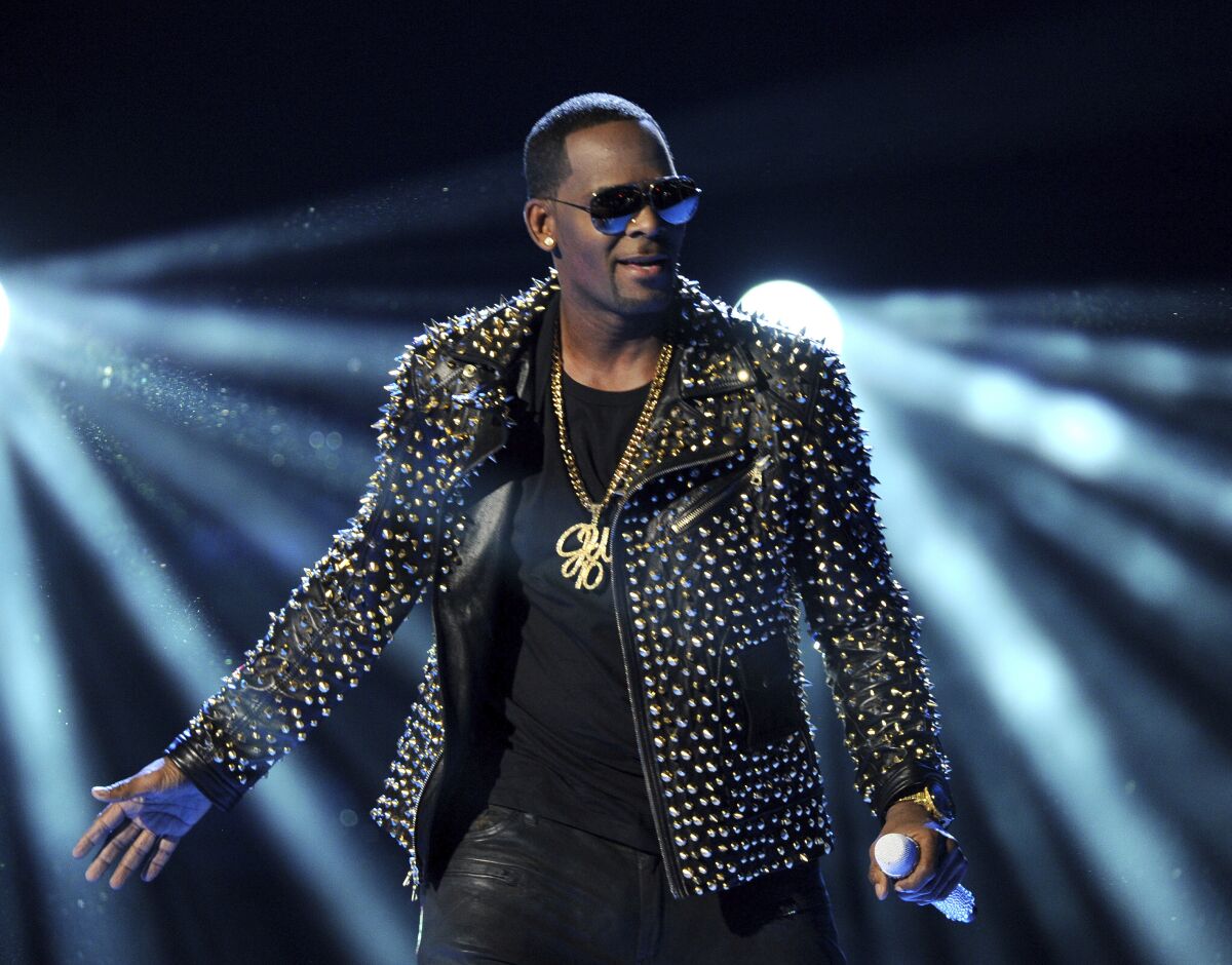 FILE - R. Kelly performs at the BET Awards on June 30, 2013, in Los Angeles. R. Kelly’s new lawyers are asking a judge to postpone his Aug. 9, 2021, sex trafficking trial in New York City, arguing they haven’t had enough time to prepare because he’s under a mandatory jail quarantine. (Photo by Frank Micelotta/Invision/AP, File)