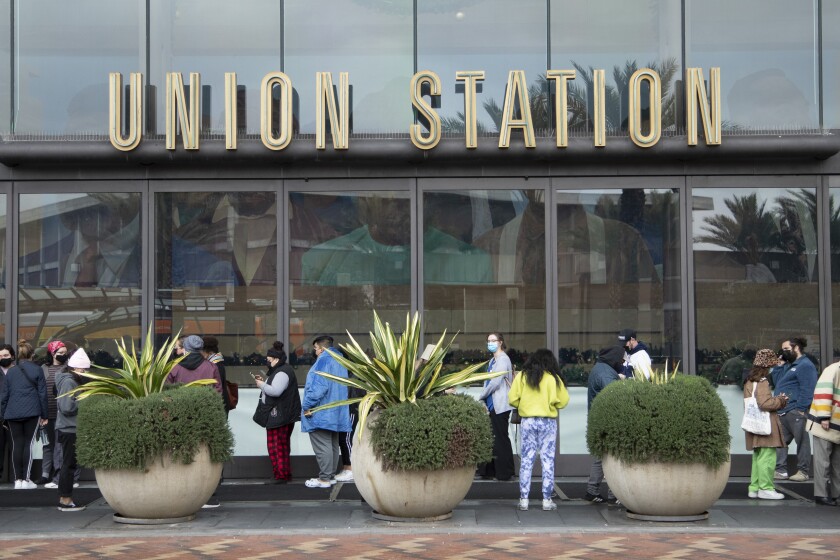 LOS ANGELES, CA - DECEMBER 27: People wait in line to get the COVID-19 test at Union Station on Monday, Dec. 27, 2021. In L.A. County, new coronavirus cases are dramatically increasing. (Myung J. Chun / Los Angeles Times)