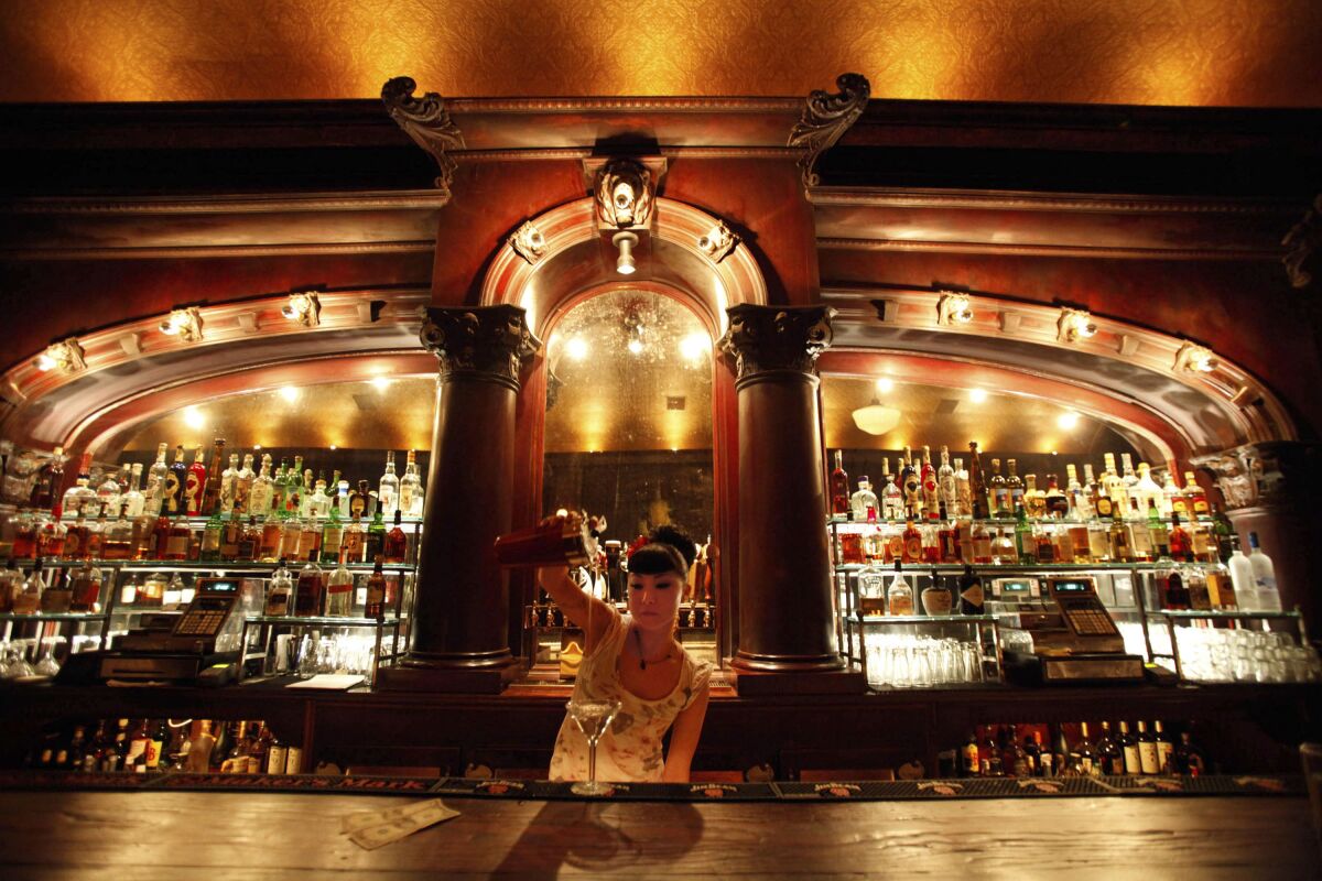LOSANGELES.ET.1031: Bartender "Miyuki" pours a drink Oct. 29, 2011 at Monty Bar ot 1222 West 7th Street in LA. MontyOs is a singular bar, a lone standout of coolness in the tough MacArthur Park area, now drawing downtown L.A. patrons for a rare night out across the 110. (Barbara Davidson/The Los Angeles Times)