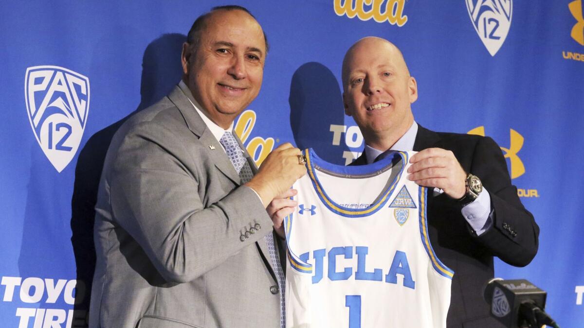 Mick Cronin, right, is introduced as UCLA’s basketball coach by athletic director Dan Guerrero on April 10.