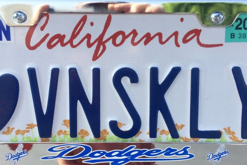 Melinda Holcomb, 64, bought a new car in June and got a customized license plate to honor legendary Dodger announcer Vin Scully.