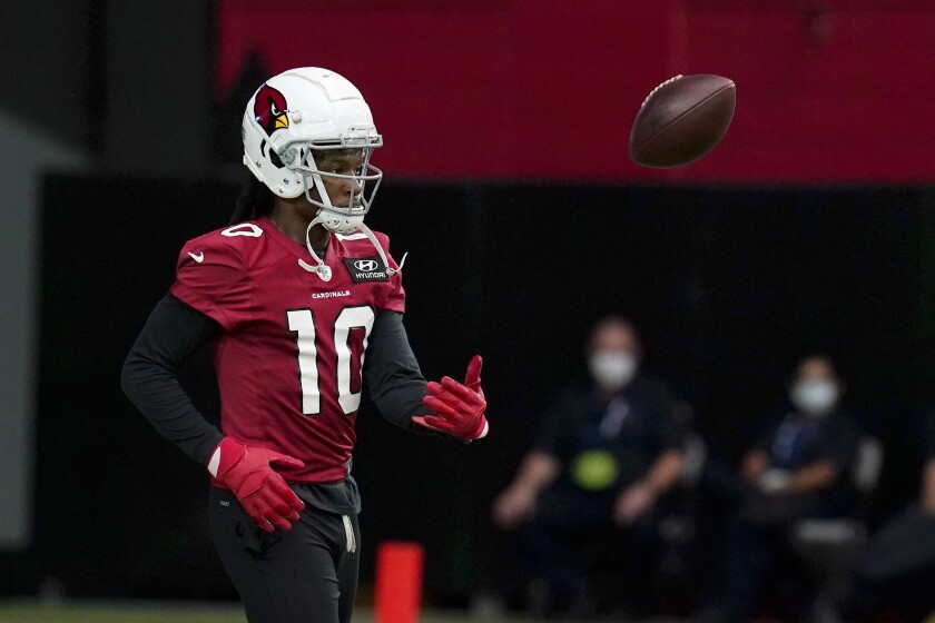 Cardinals receiver DeAndre Hopkins flips the football away after making a catch.