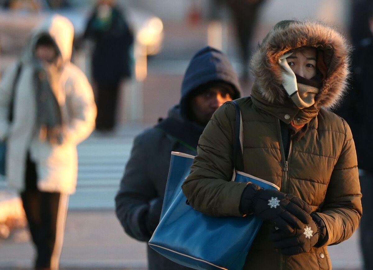 Commuters on Capitol Hill brave frigid temperatures in Washington. A so-called polar vortex that swept into the East Coast brought dangerously cold temperatures not seen in the area in about 20 years.