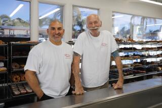 SAN DIEGO, CA - JANUARY 6: After 40 years in business, the Peterson family of Escondido has sold its Peterson's Donut Corner, a 24-hour walk-up shop in Escondido. Here, new owner Anthony Deeb, left, and outgoing owner Ralph Peterson Jr. stand in the shop on Thursday, Jan. 6, 2022. (K.C. Alfred / The San Diego Union-Tribune)