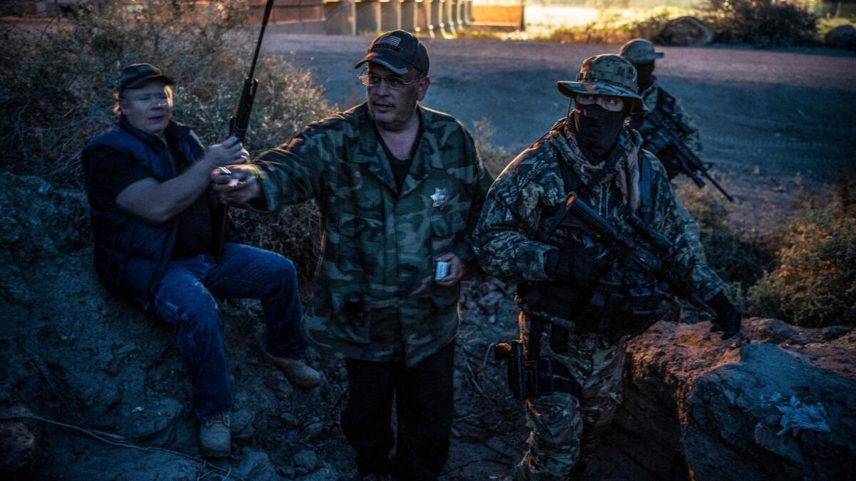 Jim Benvie, center, and other members of the United Constitutional Patriots patrol the U.S.-Mexico border in Sunland Park, N.M. Benvie said the militia group was assisting a "stressed and overstrained Border Patrol."