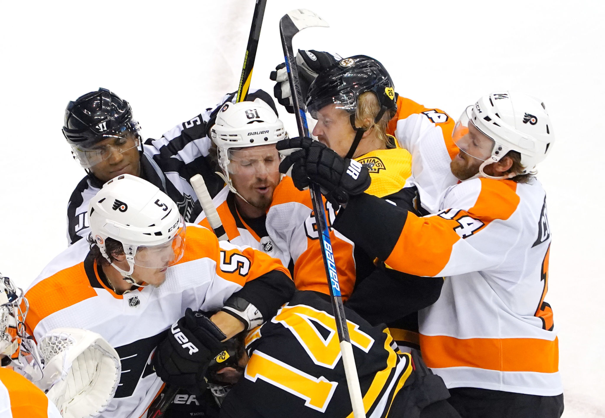 Members of the Boston Bruins and Philadelphia Flyers scuffle