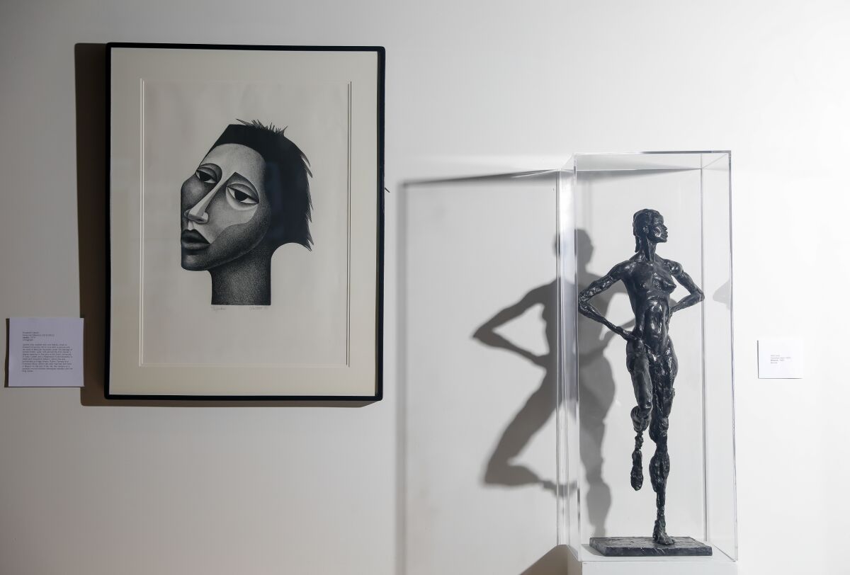A piece by Elizabeth Catlett, left, and Artis Lane, right, are displayed in The Kinsey Collection Exhibition at SoFi Stadium.