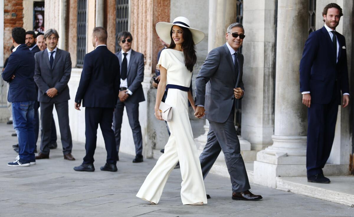 George Clooney and Amal Alamuddin arrive at the palazzo Ca'Farsetti in Venice for a civil ceremony to make their marriage official.