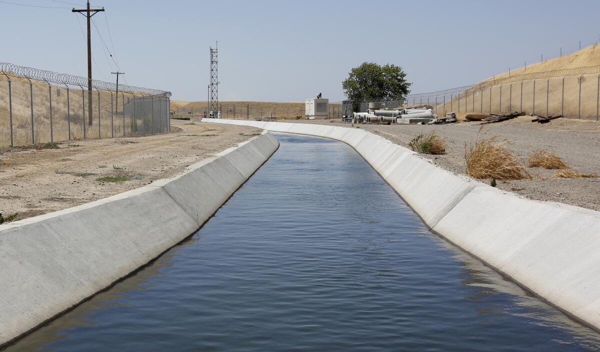 Water flows down a diversion canal operated by the Byron-Bethany Irrigation District near Byron, Calif.