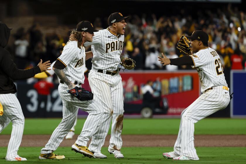 San Diego, CA - October 15: The San Diego Padres celebrate after defeating the Los Angeles Dodgers 5-3 in game 4 of the NLDS at Petco Park on Saturday, Oct. 15, 2022 in San Diego, CA. (K.C. Alfred / The San Diego Union-Tribune)