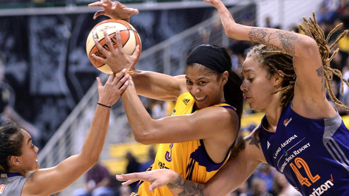 Sparks forward Candace Parker drives between Phoenix guard Emma Cannon, left, and center Brittany Griner (42) during the first half of Game 2 on Thursday.