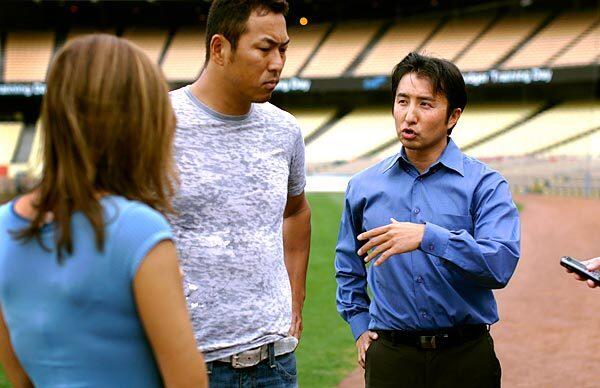 Kenji Nimura, right, translates for Dodgers pitcher Hiroki Kuroda during an interview at Dodger Stadium. Nimura is also fluent in Spanish and translates for some Latino players on the team.