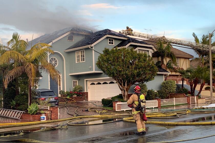 A three-alarm house fire broke out Tuesday on Huntington Harbour's Venture Drive.