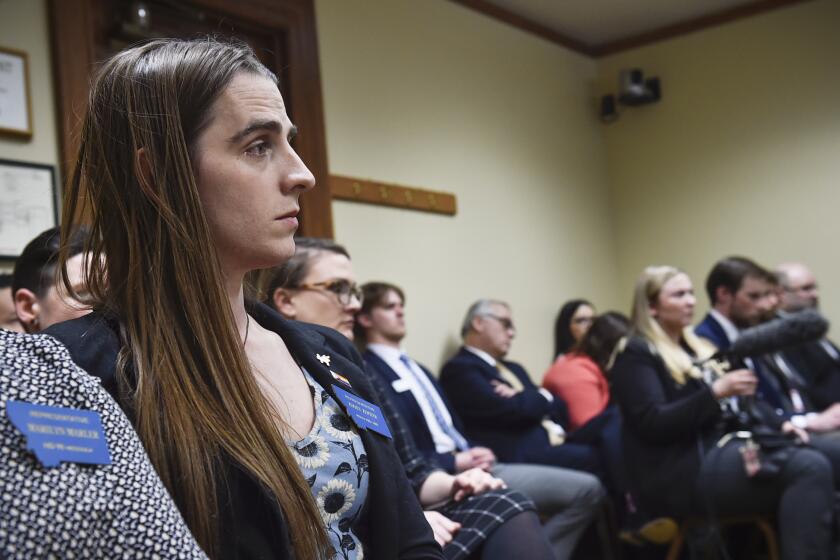 Rep. Zoey Zephyr, D-Missoula, watches a House Rules Committee meeting on Thursday, April 20, 2023 in the state capitol in Helena, Mont. (Thom Bridge/Independent Record via AP)