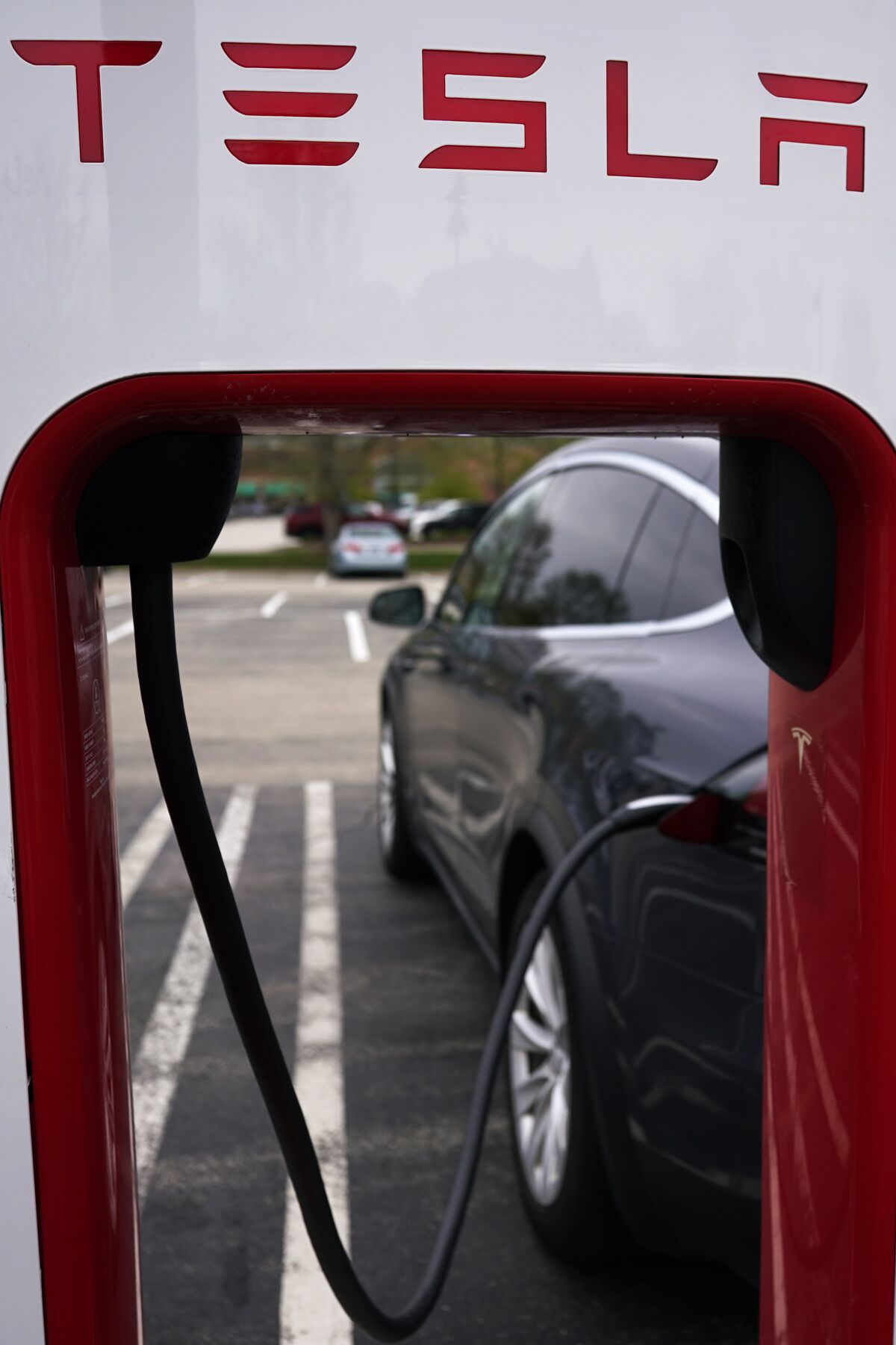 Tesla Supercharger is seen at Willow Festival shopping plaza parking lot in Northbrook, Ill., Thursday, May 5, 2022. Tesla is recalling about 130,000 vehicles across its U.S. model lineup, Tuesday, May 10, because the touch screens can overheat and go blank. The recall covers certain Model S sedan and Model X SUVs from 2021 and 2022, as well as Model 3 cars and Model Y SUVs from 2022. (AP Photo/Nam Y. Huh)