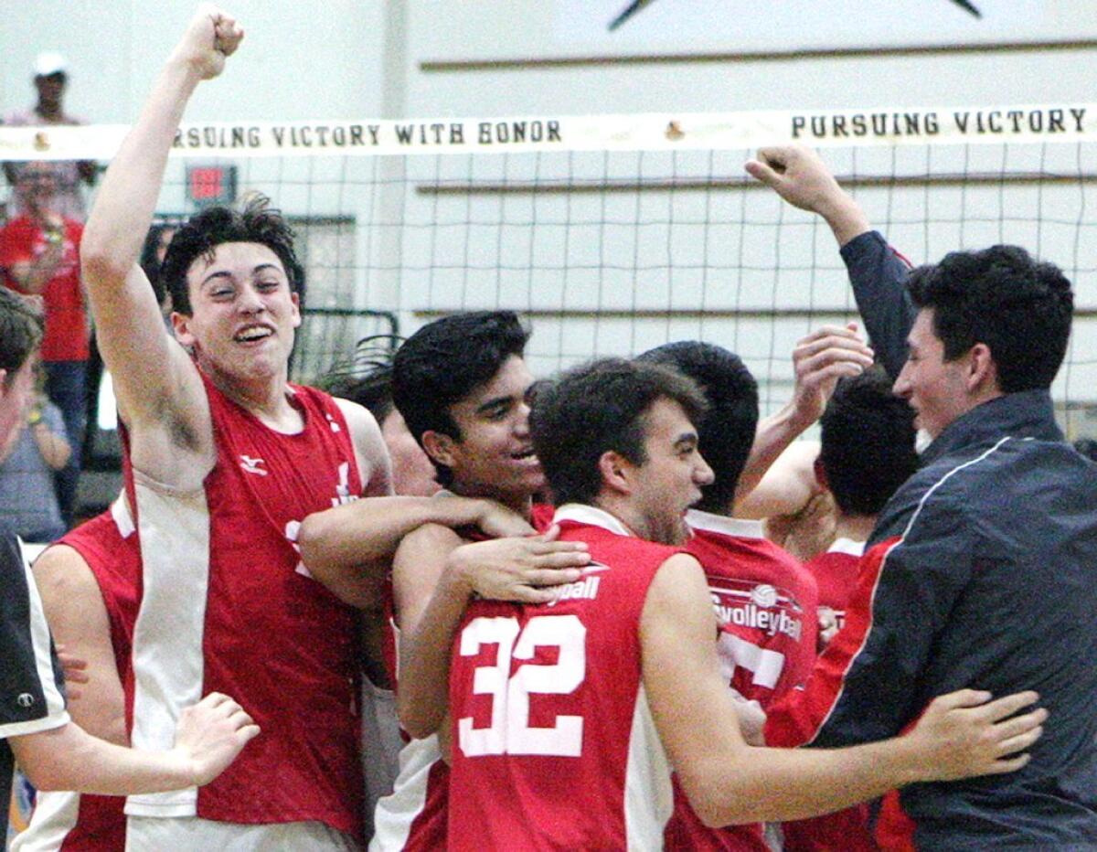 Burroughs High's boys' volleyball team celebrates its CIF Southern California Division II Regional Championship win over Oak Park on Saturday.