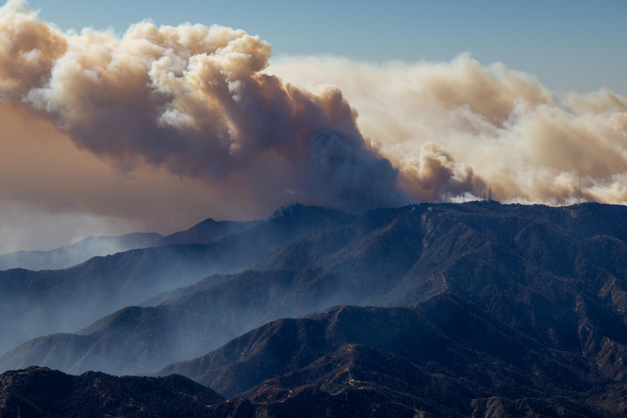 Smoke fromtthe Eaton Fire billow Southward as flames climb Mount Wilson toward its broadcast towers on Thursday.
