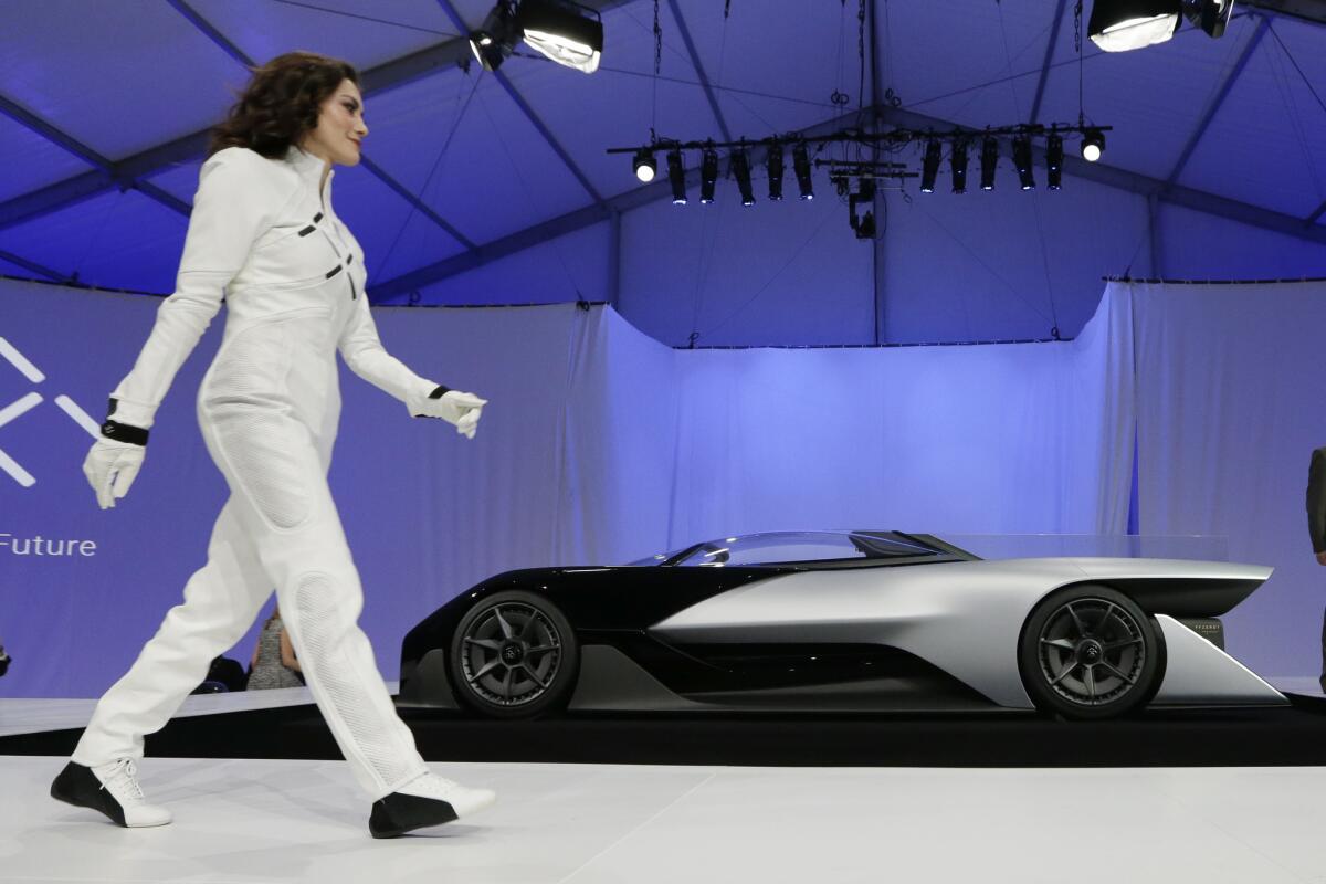 A driver walks in front of the FFZero1 by Faraday Future at CES Unveiled, a media preview event for CES International in Las Vegas in January.