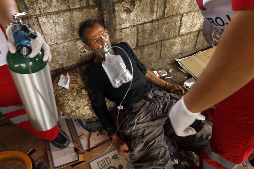 Mexicali, Mexico-June 5, 2023-A man who overdosed after shooting up in downtown Mexicali remained there for close to three hours before police arrived. Red Cross paramedics arrived soon after to assist with oxygen and take him to the hospital. He was still breathing. Most all of the heroin and meth drugs in Mexicali have traces of fentanyl, leading to a high death rate amongst addicts. Even if they wanted to avoid fentanyl, it would be impossible. (Carolyn Cole / Los Angeles Times)