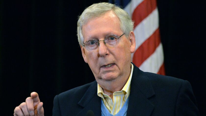 Senate Majority Leader Mitch McConnell (R-Ky.) answers reporters' questions during a news conference Saturday in Louisville, Ky.