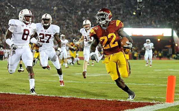 Trojans tailback Curtis McNeal gets to the end zone ahead of Cardinal defenders for a touchdown in the third quarter Saturday night at the Coliseum.