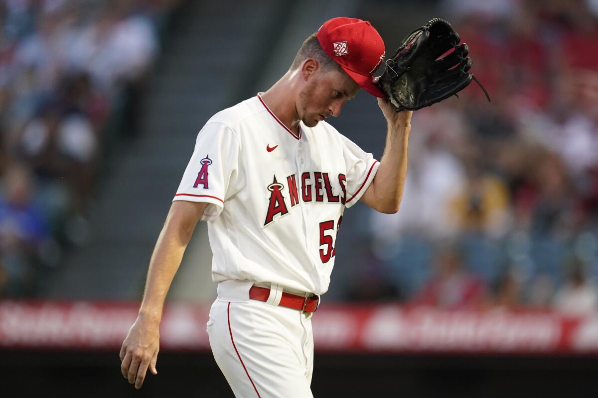 Angels starter Cooper Criswell leaves the game after he was removed during the second inning Aug. 27, 2021.