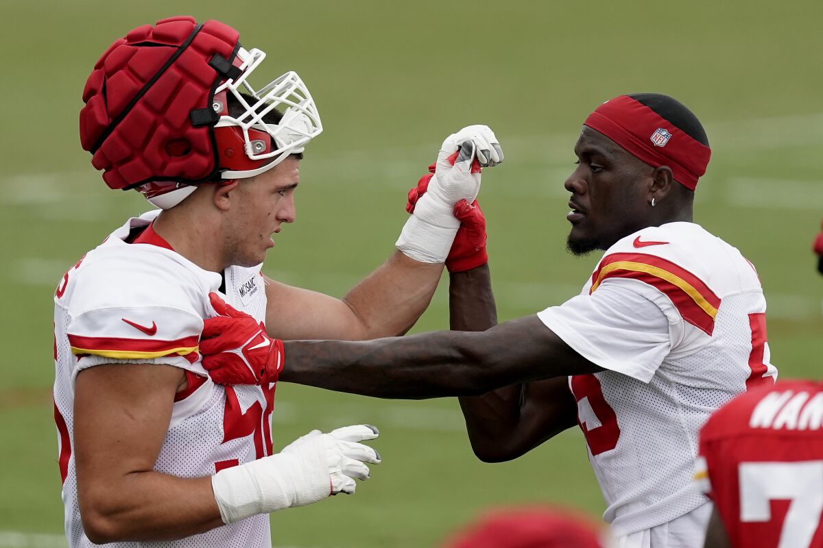 Kansas City Chiefs defensive end George Karlaftis, left, works with defensive end Frank Clark, right, during NFL football training camp Monday, Aug. 15, 2022, in St. Joseph, Mo. (AP Photo/Charlie Riedel)