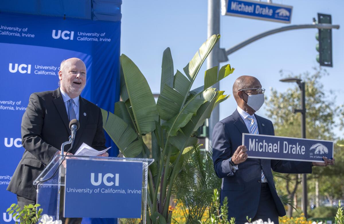 UCI Chancellor Howard Gillman, left, speaks, as UC President Michael Drake looks on.