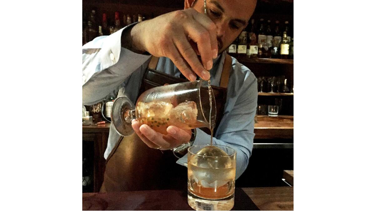 Bartender Justin Park pours one of his cocktails at Bar Leather Apron in downtown Honolulu.