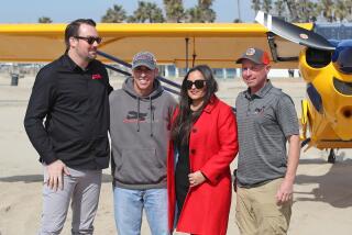 Pacific Airshow executive director Kevin Elliott, pilot Bruce Graham, Huntington Beach Mayor Gracey Van Der Mark, and pilot Casey Pozdolski, from left, Visit Huntington Beach arrive to the Pacific Airshow press conference on the beach at the end of Huntington St. in Huntington Beach on Thursday.