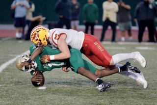 Mission Viejo defensive end Jaden Williams sacks Poly quarterback Darius Curry in the first quarter Friday night.