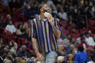 Los Angeles Lakers forward Anthony Davis watches during the second half of an NBA basketball game against the Miami Heat, Sunday, Jan. 23, 2022, in Miami. Miami won 113-107. (AP Photo/Lynne Sladky)