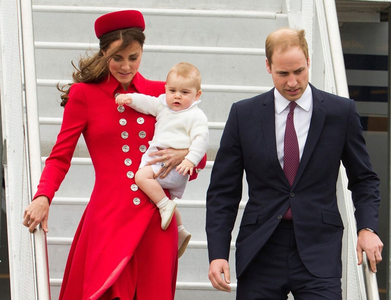 Prince William and Catherine arrive in Wellington, New Zealand, with their son Prince George. The family was scheduled to be New Zealand April 7-16. The duchess wears a scarlet Catherine Walker coat and a Gina Foster hat.