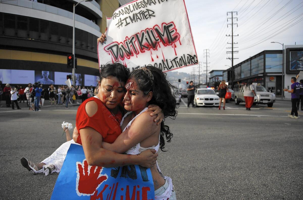 Jennicet Gutierrez, left, and Johanna Saavedra embrace duing a demonstration in Los Angeles in March. The "Spring into Love" rally protested violence against transgender people.