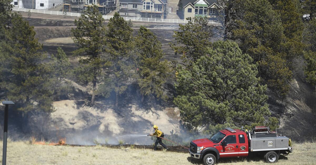 Un bombero combate las llamas el viernes 22 de abril de 2022, en Colorado Springs, Colorado. 
