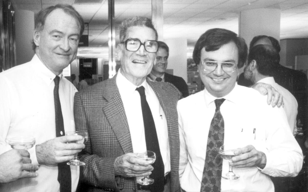  Jim Murray, third from left, shares a toast with Sports Editor Bill Dwyre, second from left, and John Cherwa, right.