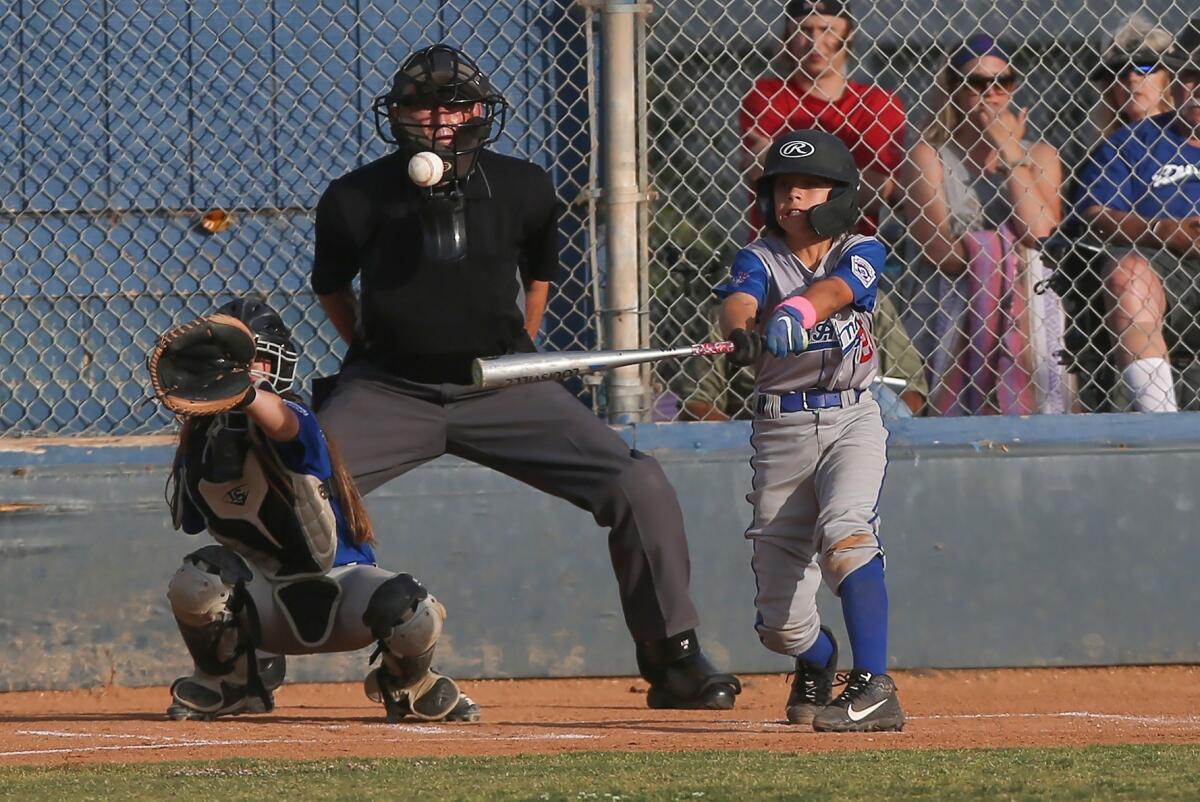 Costa Mesa National Little League's Sawyer Atkinson hits a double in a District 62 Tournament of Champions Major Division quarterfinal game against Huntington West on Tuesday at Ocean View Little League.