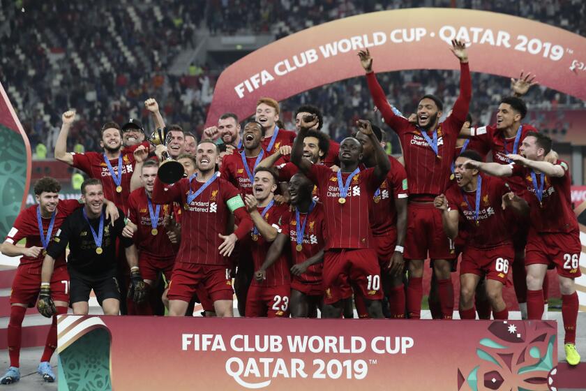 Players of Liverpool celebrate after winning the Club World Cup final soccer match between Liverpool and Flamengo at Khalifa International Stadium in Doha, Qatar, Saturday, Dec. 21, 2019. (AP Photo/Hassan Ammar)