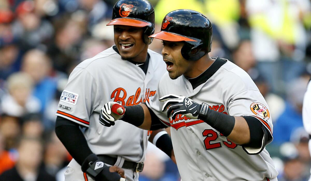 Orioles designated hitter Nelson Cruz (23) celebrates with center fielder Adam Jones after hitting a two-run home run against the Tigers in the sixth inning of Game 3 on Sunday.