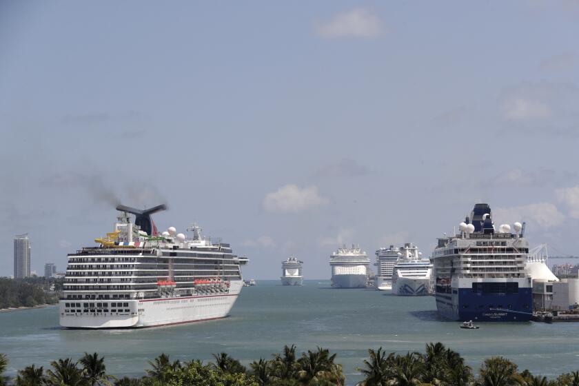 FILE - Cruise ships float at PortMiami, on April 7, 2020, in Miami. The U.S. Centers for Disease Control and Prevention is now warning people not to cruise regardless of their vaccination status because of an increase in cases fueled by the omicron variant detected in ships. (AP Photo/Lynne Sladky, File)