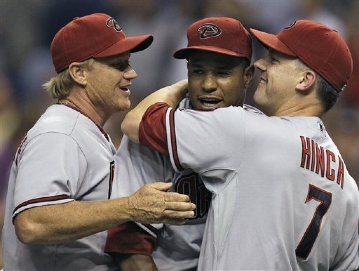 Arizona Diamondbacks pitcher Randy Johnson, right, hugs his